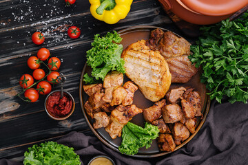 Grilled barbecue meat assortment on dark wood