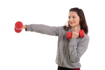 Healthy teenage girl boxing with hand barbell, smiling.