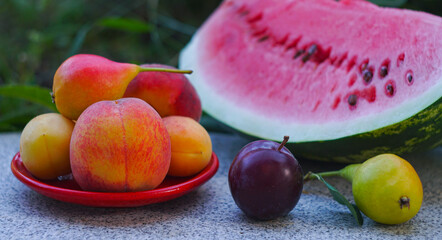 Various fruits and a slice of watermelon