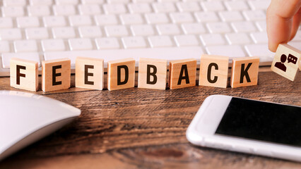 Letters on wooden pieces concept, business background with the word Feedback - 536709270