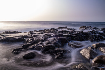 sunset and waves over the sea