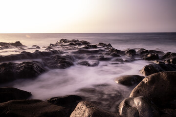 sunset and waves over the sea