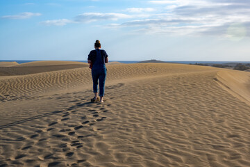 person walking on the sand