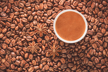 Turkish coffee cup on roasted coffee beans. Top view with close up.
