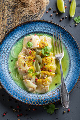 Tasty pickled fish serving with coriander and lime.