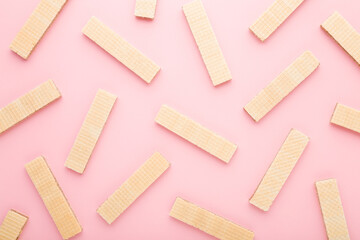 Dry wafers on light pink table background. Pastel color. Closeup. Sweet snacks pattern. Top down view.