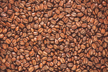 Roasted coffee beans background. Top view with copy space.