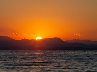 sunrise over the sea with mountains