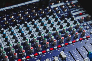Close-up shot of an audio mixer . Detail of a music mixer in studio, dj working for a new song