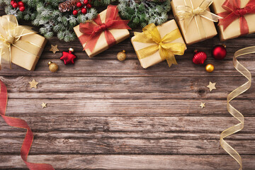 Frame from Christmas gifts or presents with holiday decorations and snowy fir tree on wooden table top view.