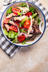 salad chicken breast, tomato, green lettuce, red onion healthy meal food snack diet on the table copy space food background rustic top view keto or paleo diet