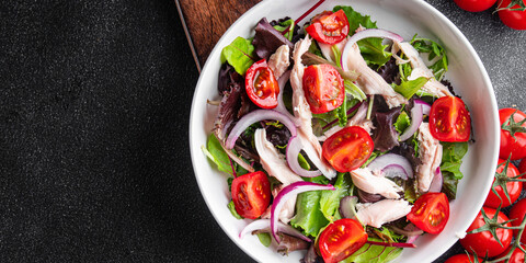 salad chicken breast, tomato, green lettuce, red onion healthy meal food snack diet on the table copy space food background rustic top view keto or paleo diet