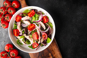 salad chicken breast, tomato, green lettuce, red onion healthy meal food snack diet on the table copy space food background rustic top view keto or paleo diet
