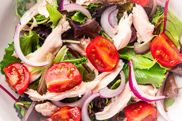 salad chicken breast, tomato, green lettuce, red onion healthy meal food snack diet on the table copy space food background rustic top view keto or paleo diet