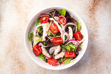 salad chicken breast, tomato, green lettuce, red onion healthy meal food snack diet on the table copy space food background rustic top view keto or paleo diet