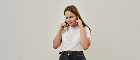 Female teenage listen music in wireless earphones © Svitlana