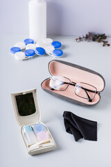 Box for storing contact lens care items and glasses in a case. Choosing correction method. Vertical