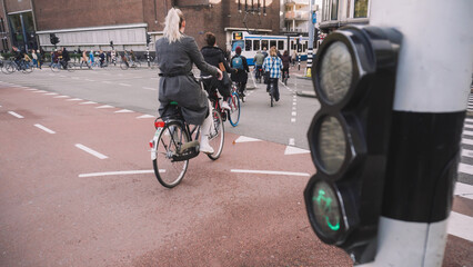 Bikes and bikers are riding in Amsterdam	