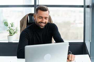 Businessman works at the office behind a laptop