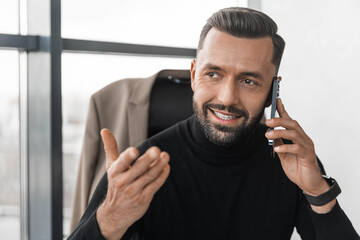 Businessman talking on mobile phone and gesticulating