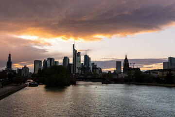 Fototapeta na wymiar Sunset in the city of Frankfurt, seen from the Bubis bridge, view of the old part of the city and the financial and office area.