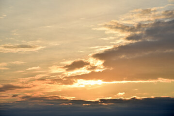 Sunset sky with pink and blue clouds in summer. Beautiful sunset with the sun.