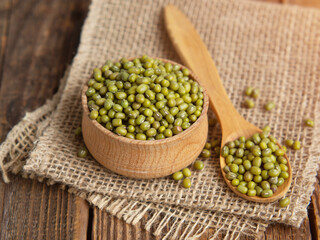 Close-up mung beans .Green mung beans in a wooden bowl on an old table