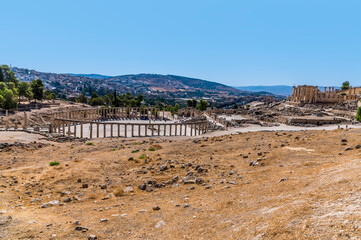 A view over the side of the Oval Plaza in the ancient Roman settlement of Gerasa in Jerash, Jordan in summertime