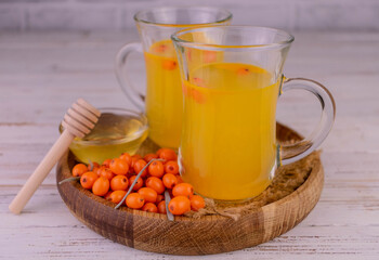 Sea buckthorn juice with fresh, ripe, berries. Healthy food. Close-up. 
