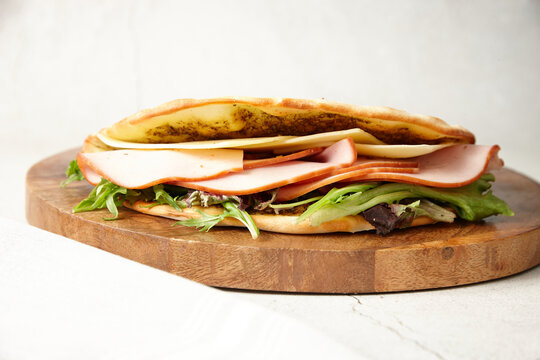 close up shot of a ham and cheese zaatar
