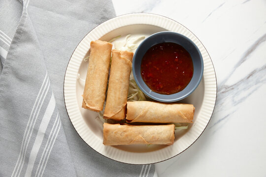 top shot of spring rolls with ketchup