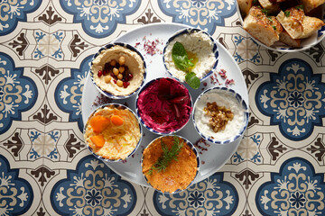 different flavours of hummus one one plate