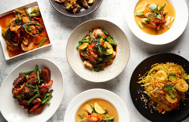 Multiple bowls of different thai food