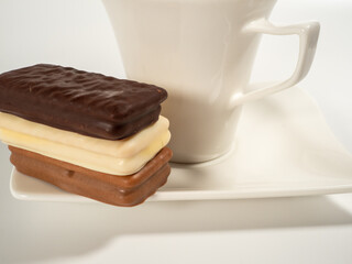 Chocolate bar and a cup of coffee on a white background.