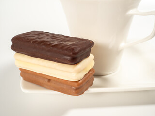 Chocolate bar and a cup of coffee on a white background.