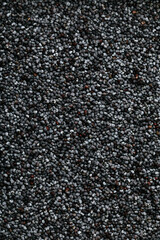 Poppy Seeds Background. Dark dry raw poppy seeds background. Abstract background