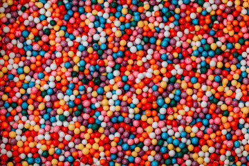 Sugar sprinkle dots background. Colorful decoration for cake