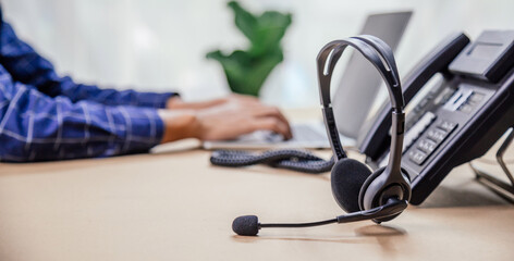 Communication support, call center and customer service help desk. telephone devices with VOIP headset in office.Customer service support (call center) concept.