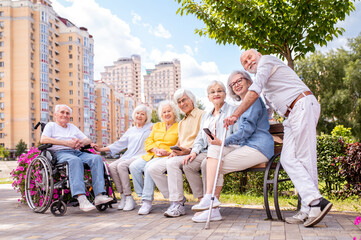 Group of seniors people bonding at the park - Elderly old friends social gathering and spending...