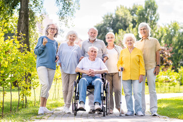 Group of seniors people bonding at the park - Elderly old friends social gathering and spending time together outdoors