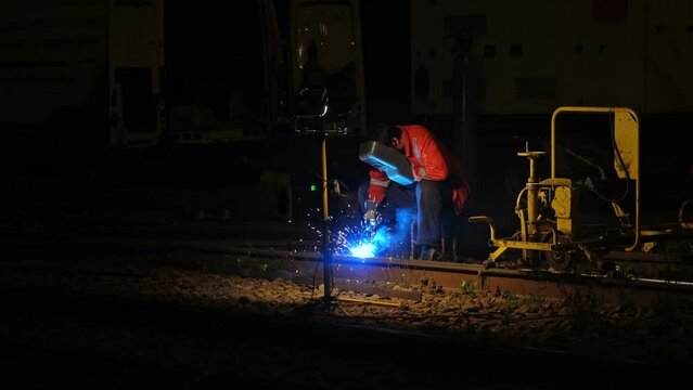 Professional Skilled Welder Working at Night Fixing Tram Railway Track using Oxy Fuel Welding Torch