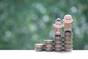 Mutual fund,Love couple senior and coins money on natural green background, Save money for prepare...