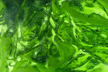 Acidic green liquid. Abstract background with light green slurry with bubbles. Background with...