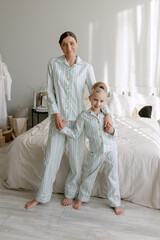 Mother and daughter look at the camera. 