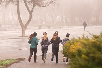 girls jogging on a foggy morning. healthy lifestyle. no autumn blues. autumn melancholy.