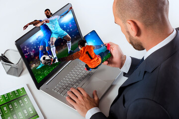 Businessman watches football match and bets on soccer website