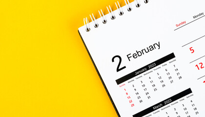 The February 2023 Monthly desk calendar for 2023 year on yellow background.