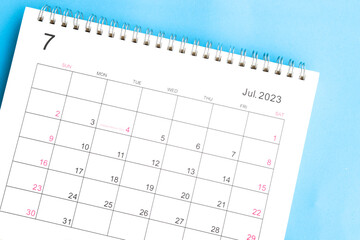 calendar July 2023 top view on a blue background - obrazy, fototapety, plakaty