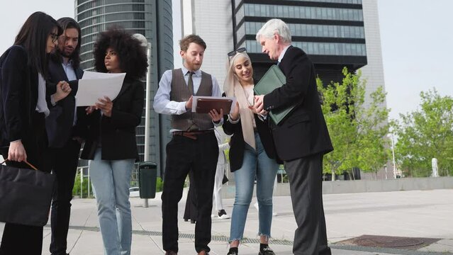 Multiracial business people having a briefing outside the office - Coworkers cooperating outdoor 