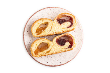 Homemade sweet bun with apricot jam isolated on white. top view.